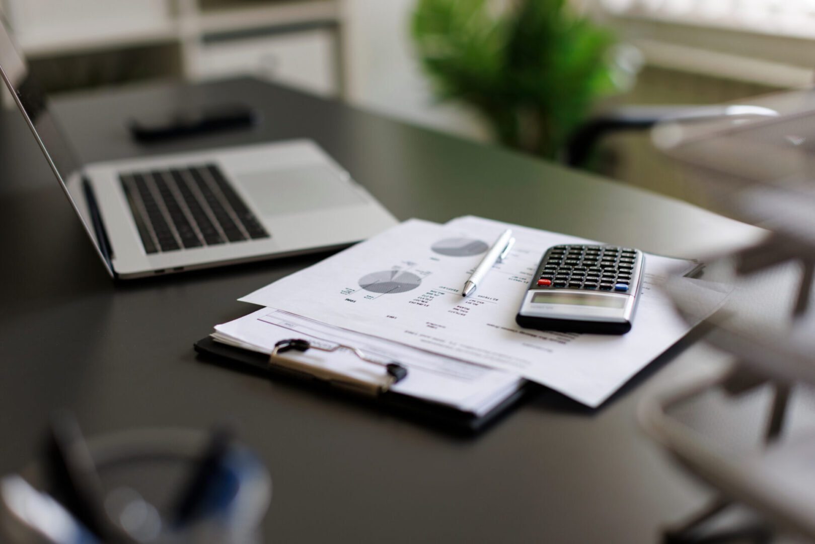 Financial documents with calculator and pen